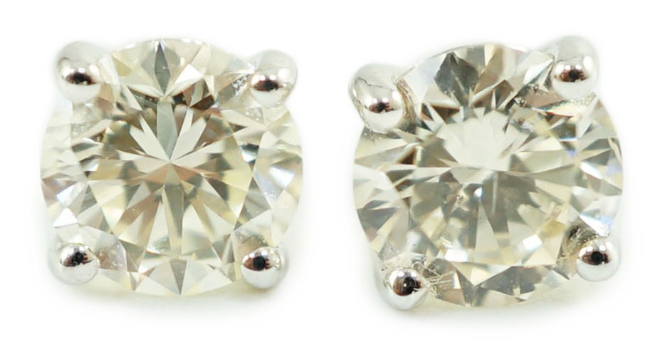 A pair of 18ct white gold and solitaire diamond set ear studs